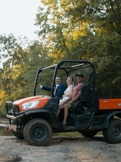 a bride and groom enjoy an off roading adventure at sunset