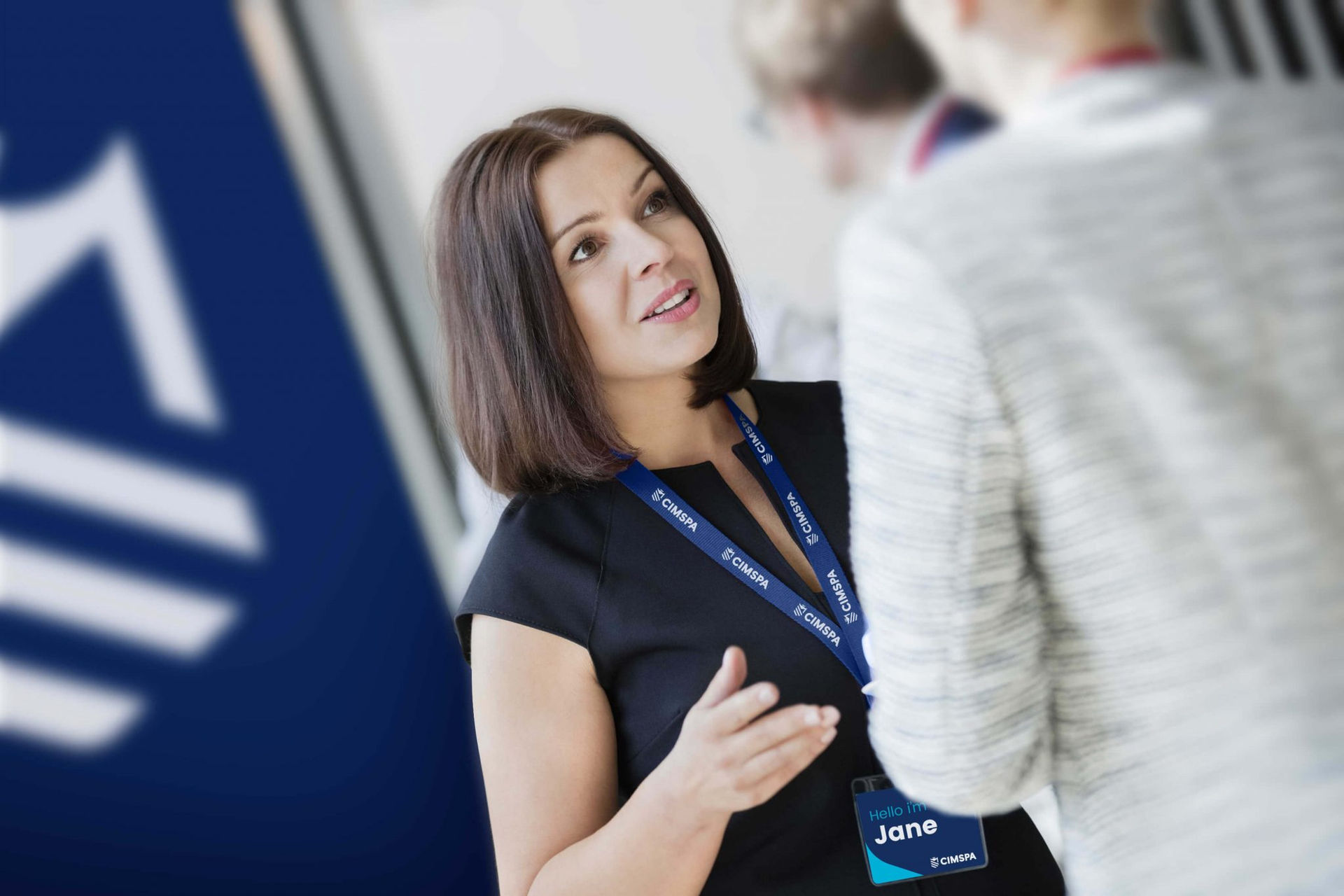 CIMSPA brand image with employee speaking at an event