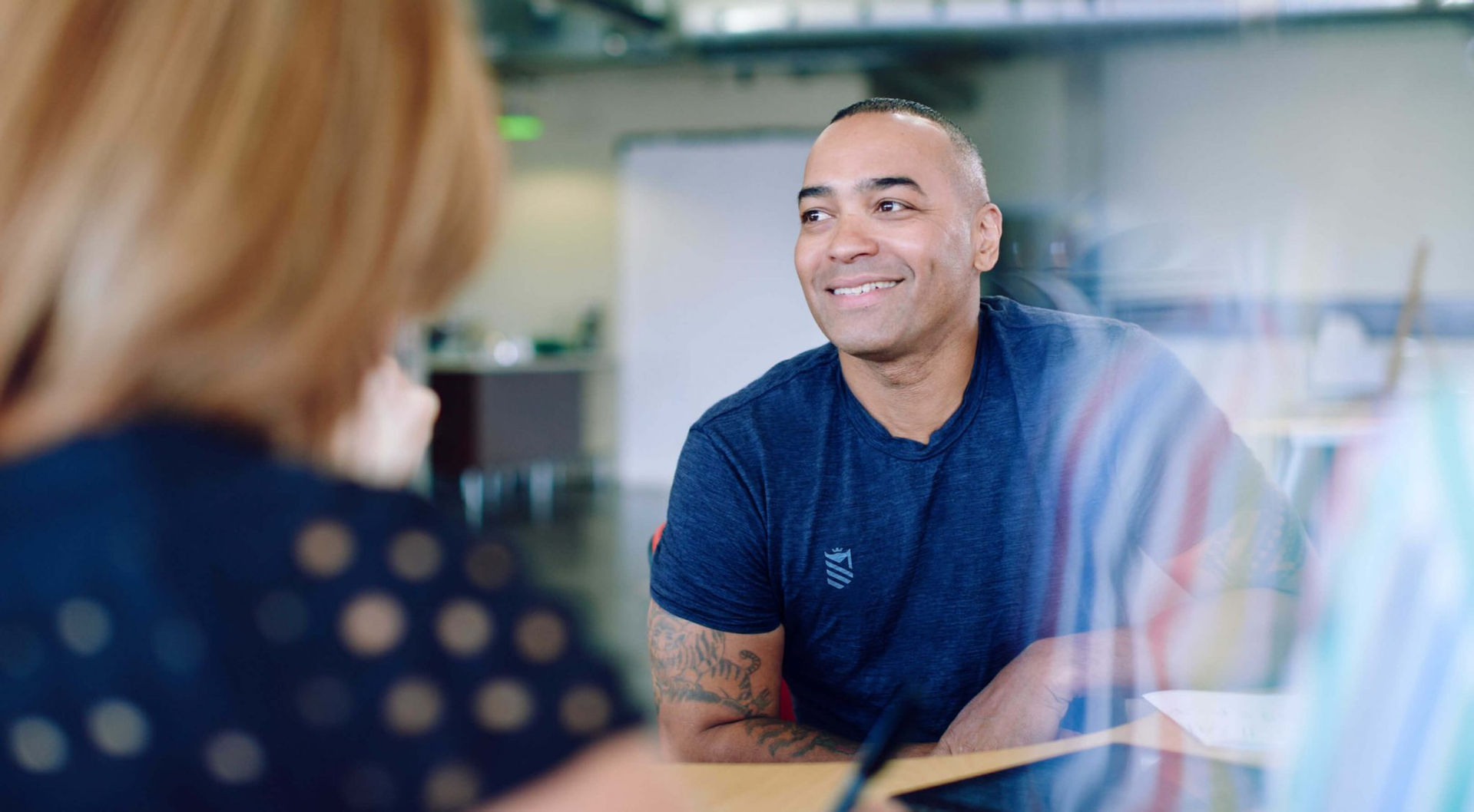 CIMSPA brand image of employee sitting at a table