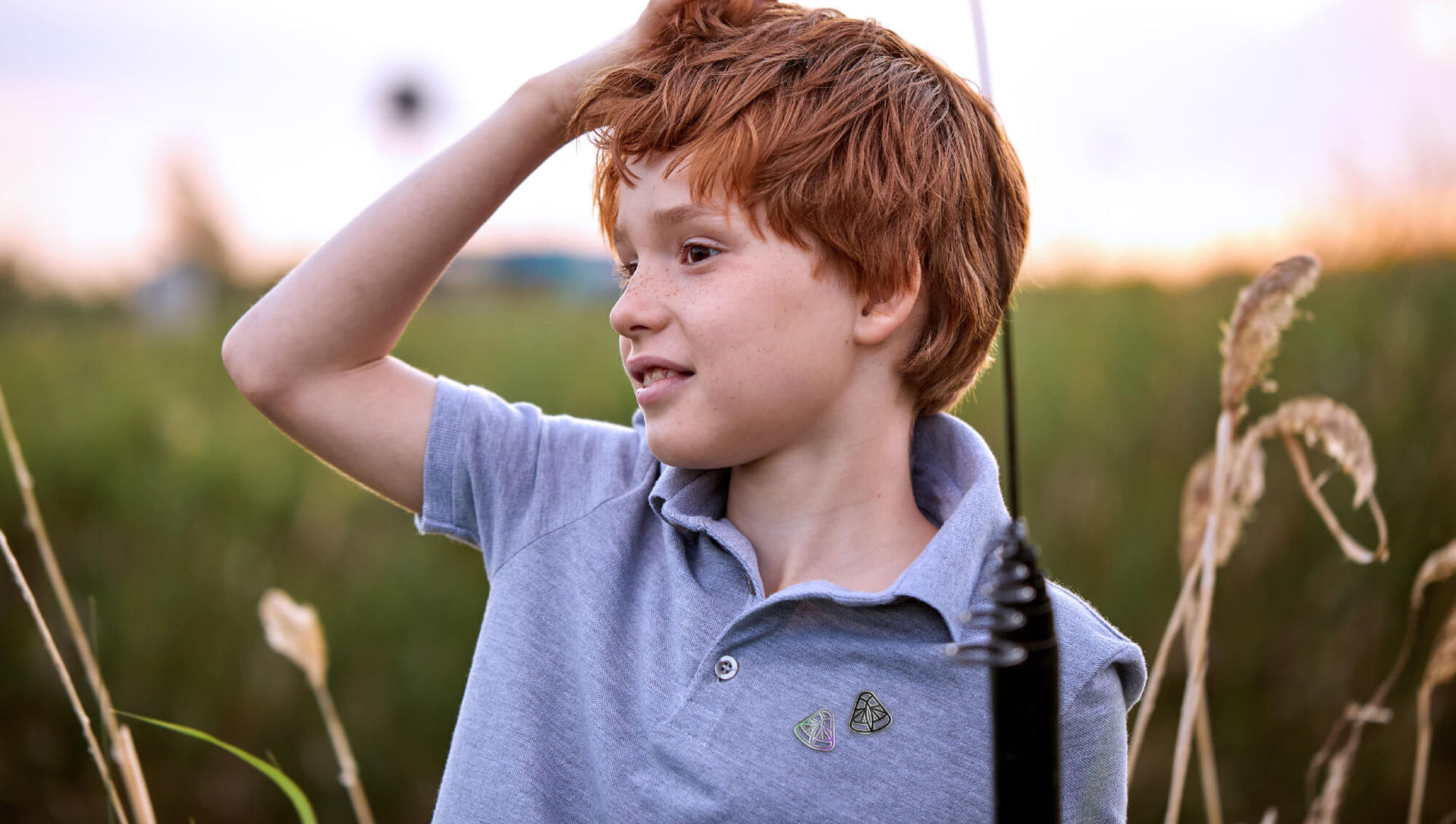 Royal Entomological Society branded photography with boy in field