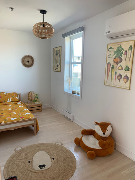 a bedroom with a bed and a stuffed animal