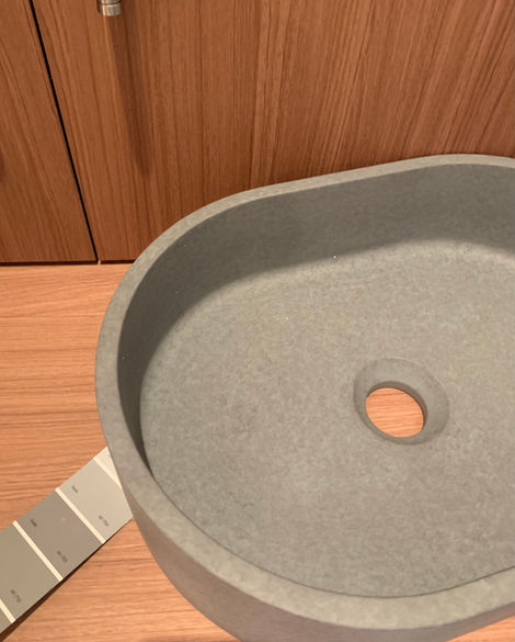 a gray sink with a hole in the middle of it