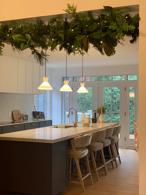 the kitchen is decorated for christmas and has a large island