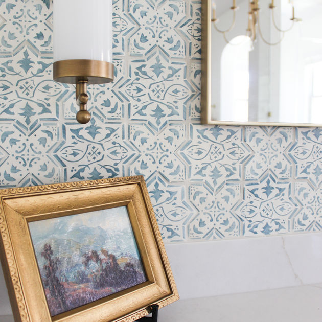 Custom bathroom vanity made of oak wood with brass hardware accents and hand painted tile.