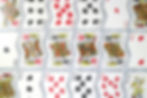 Playing cards arranged with various suits and numbers, including King, Queen, and Joker.