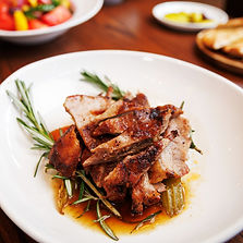 Plate of meat with rosemary, and other dishes at Skara Taverna