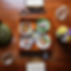 Japanese meal with sushi, salad, and fish on a wooden table