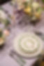 Close up of ribbed glassware, painted serveware
 and fresh spring flowers in cream, lilac and pale pink for a wedding or party
