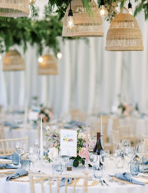 Marquee wedding with rattan lampshades and dusky blue place settings