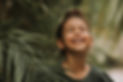 face-little-girl-surrounded-by-tropical-leaves-closeup-portrait-swarthy-kid-with-perfect-s
