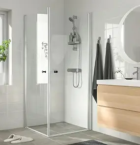 Modern frameless bathroom shower cubicle with clear glass panels and walk-in shower cubicle.