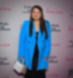 Rachelle Bravo in a bright blue suit attending a Beverly Hills event, showcasing her leadership and elegance.