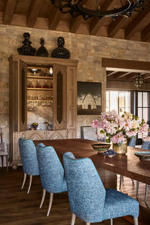 Dining room with a Tundra Cream thin veneer wall rising to an exposed timber ceiling