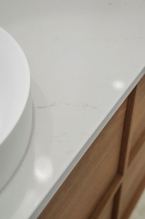 White benchtop with custom walnut vanity cabinetry in a modern coastal bathroom renovation