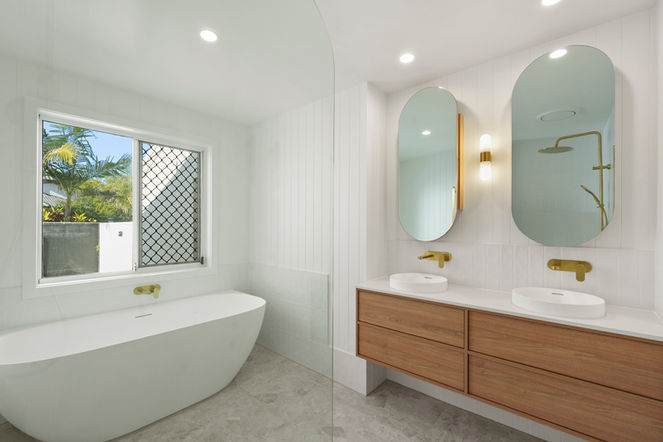 Modern coastal main bathroom and ensuite renovation featuring a freestanding bath and custom walnut double vanity
