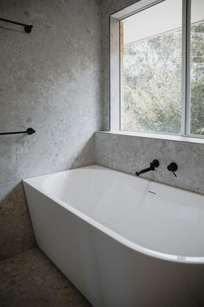Modern bathroom design in Gold Coast featuring terrazzo flooring, walk-in shower and stand alone bathtub.