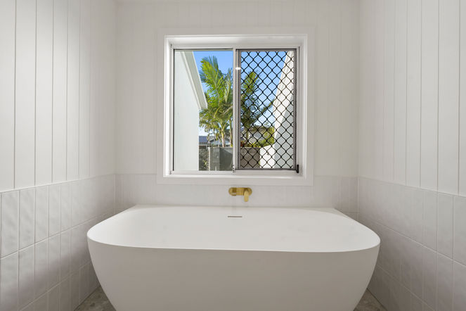 Freestanding bath framed by VJ wall panelling in a bespoke Gold Coast bathroom renovation