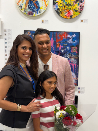 Pankti Mehta with her husband and daughter in front of her booth