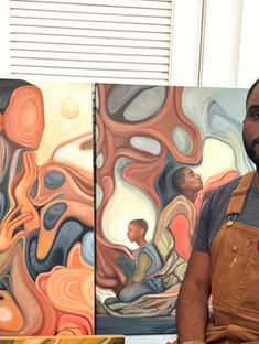 Artist Sherwin Cadore overalls sits near abstract paintings with flowing shapes and earthy tones, in a room with wooden floors and white walls.