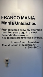 Gallery wall text displaying “Franco Manià: Mania Unleashed” with a quote by Agnes Gund