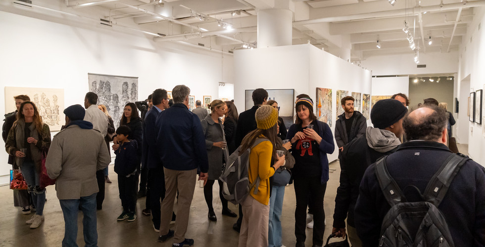 Large group of visitors gathered in the gallery during the exhibition opening