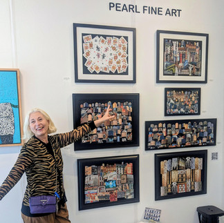 Pearl Fine Art display featuring framed collage-style works with a visitor pointing toward the wall