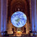 Poster for Outside: Gaia Earth installation by Luke Jerram at Cathedral of St. John the Divine, NY, with hanging Earth.