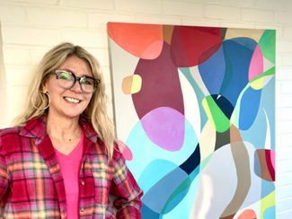 Kirsten Bowen in her studio in front of her artwork Confetti & Stone