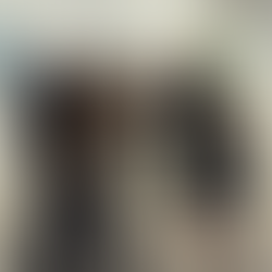 Group toasting with drinks in a gallery corridor while others, including a child, walk through the space