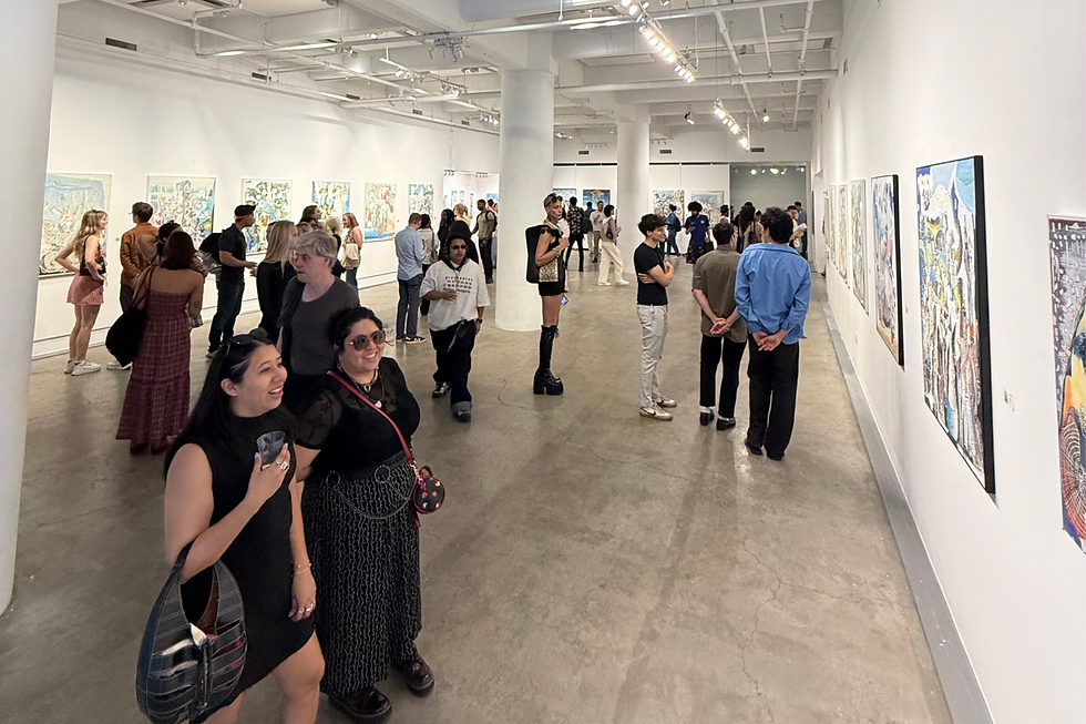 People mingle at an art gallery, viewing paintings on white walls. The mood is lively, with bright lighting and various outfits.