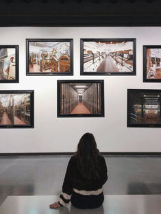 Asthetic image of a woman sitting in front of artworks image by Klaudia Piaskowska