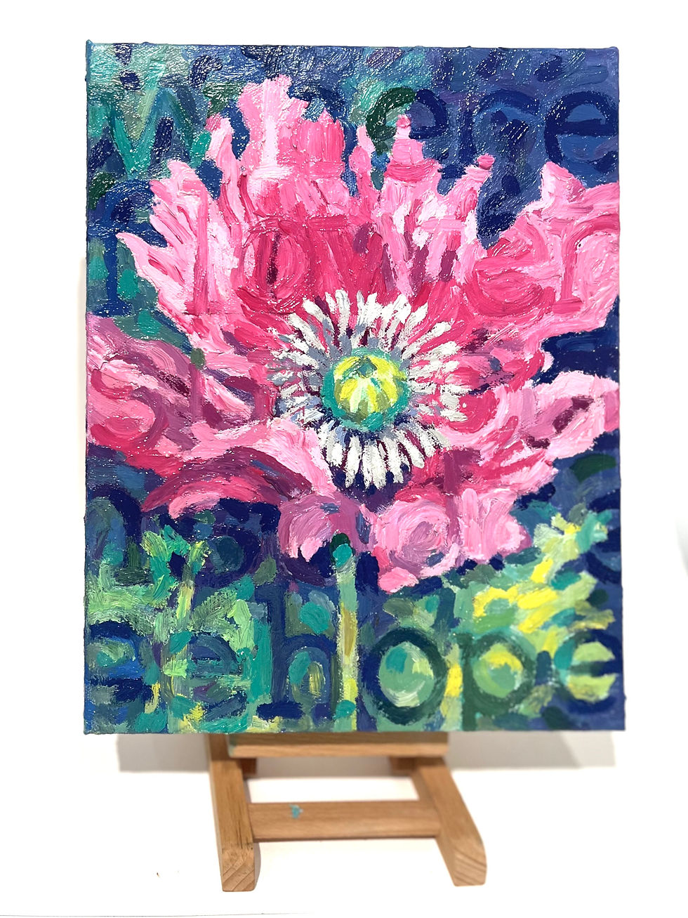 Bright pink flower painting on a blue and green background with faint text. Displayed on a wooden easel, conveying vibrant energy.