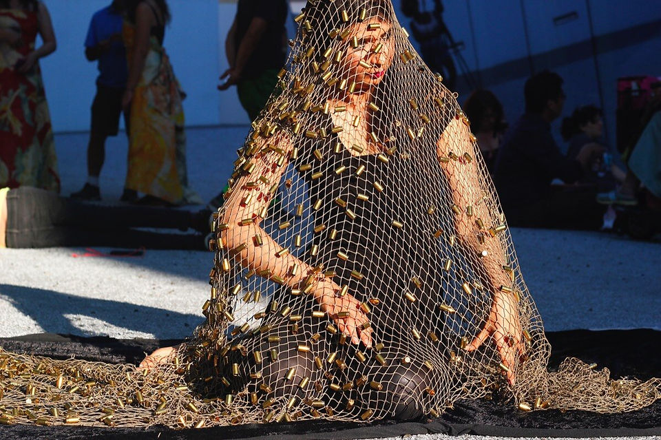Qinza Najm performing #NOHONORINHONORKILLING with a veil of bullets