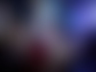 Bride and groom surrounded by friends singing and celebrating on a packed wedding dance floor in Calgary