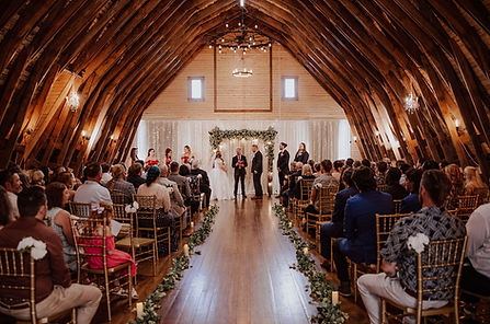 Indoor wedding ceremony in wooden chapel with guests seated