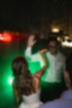 bride and groom high five on the dance floor at their fernie lziard lounge wedding, with wedding DJ covered by Mico Entertainment