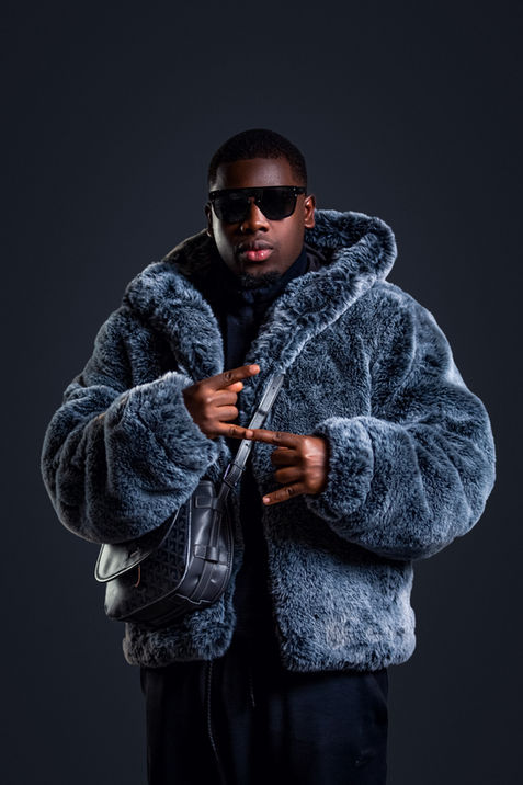 Stylish entrepreneur wearing a bold fur coat and sunglasses in a unique studio headshot session