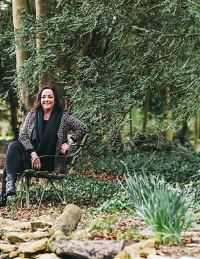 Holly sitting on a bench next to the stream at Matara