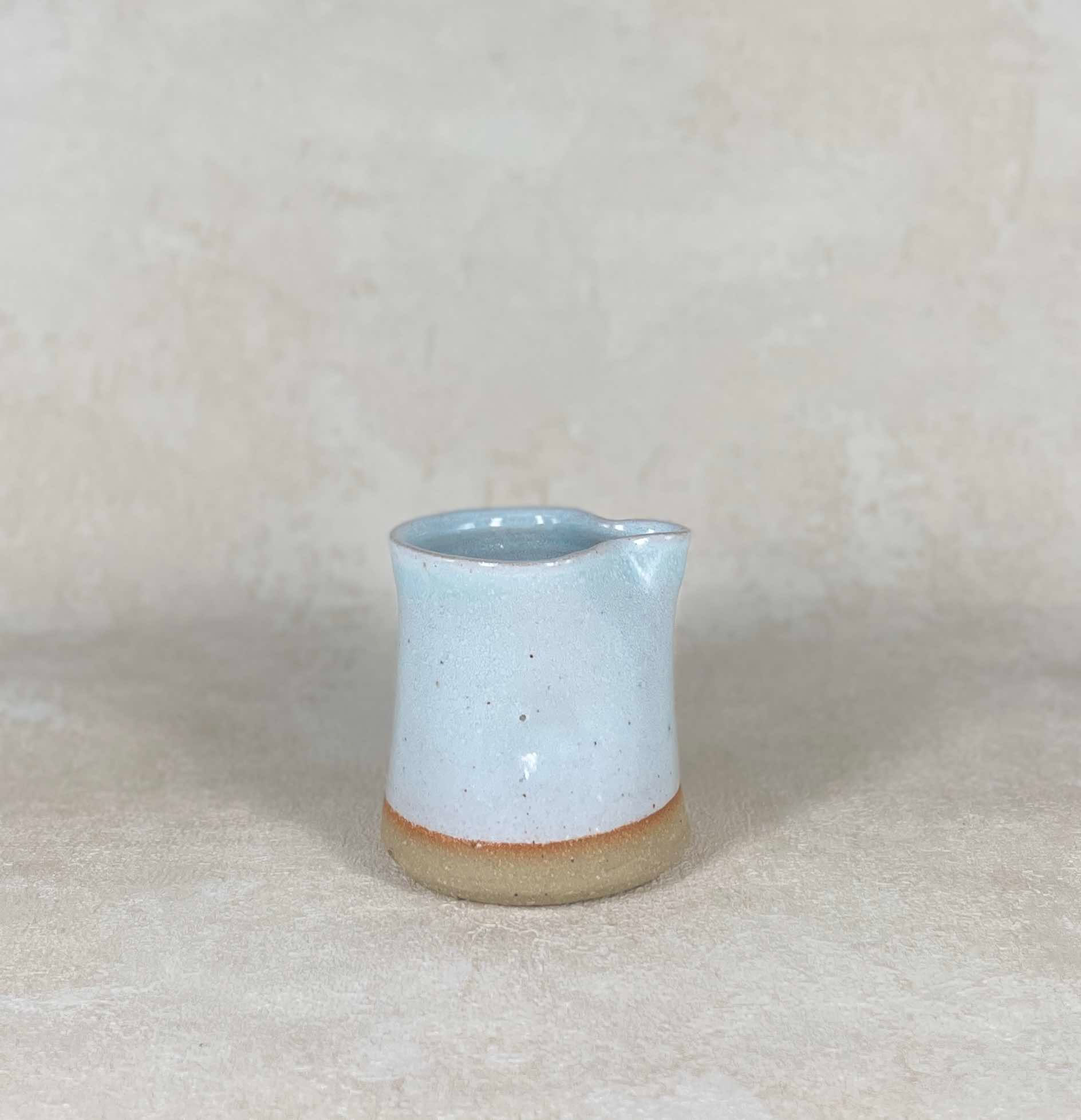 signed studio pottery hand thrown jug with celadon soft blue glaze, handleless creamer jug, small studio milk jug.