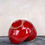 Thumbnail: rich red glazed bowl sculpture with twisted ribbon on top Garcia Arroyo, boho chic, minimalistic decor.