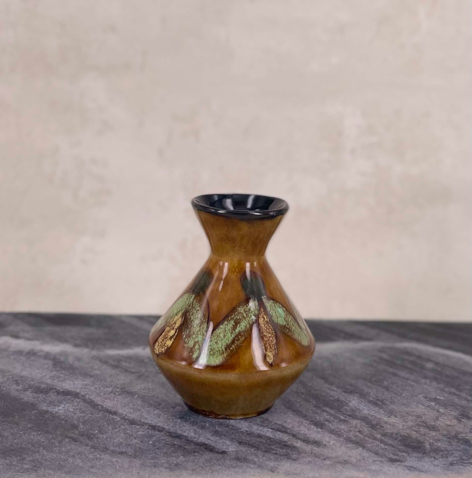 vintage ceramic studio bud vase, hand finished in a richly mottled brown and green glaze with natural variation. MCM interior