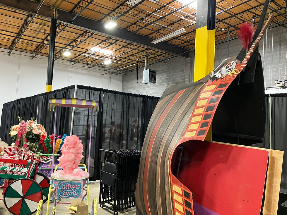 The confectionery carts from Act II of The Nutcracker are stored by the Rat King's ship, which was constructed to stand on its stern to fit off-stage. Beyond the curtains, students take class in our temporary studio.