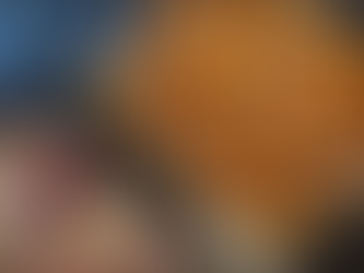 chopped veggies on a roasting pan next to a wooden cutting board with onions