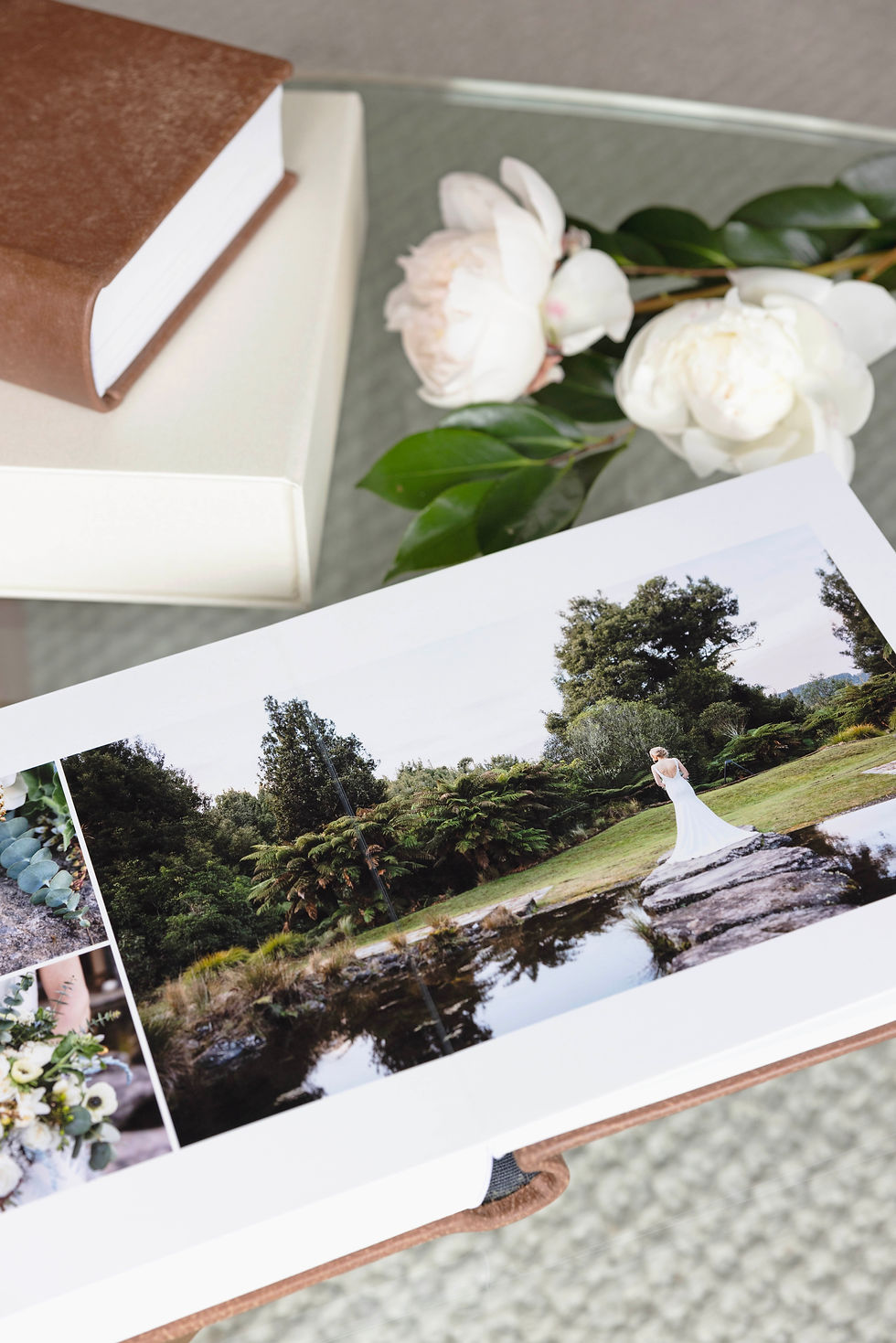 Queensberry Wedding Album open to a page showing a beautiful bride next to the pond at Treetops Lodge, Wedding Venue in Rotorua. Photographed by Rose Minnee Photography.