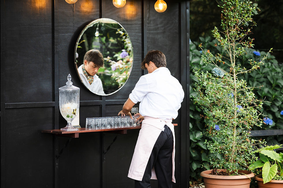 Bar Staff setting up glasses ready for wedding guests arrival to Bay of Plenty Wedding Venue, Old Forest School. Photographed by Rose Minnee Photography