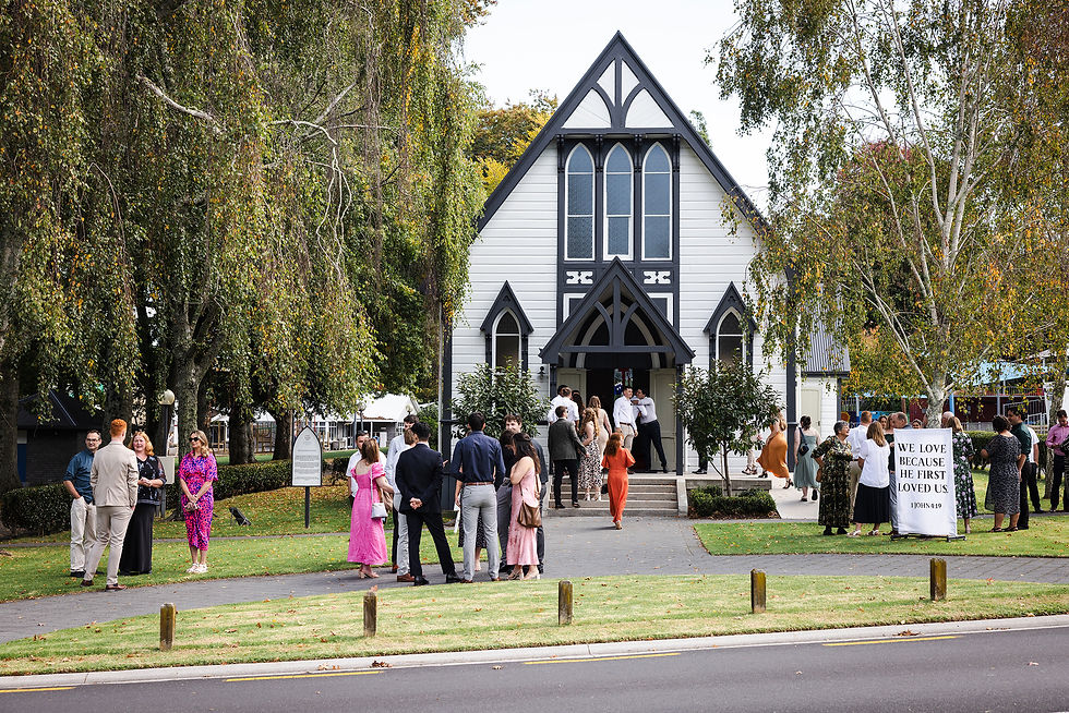 Wedding guests waiting outside Bethlehem College Chapel before a wedding ceremony. Photographed by Tauranga Wedding Photographer Rose Minnee