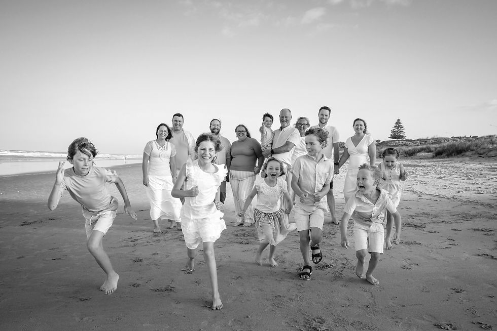 Extended family photoshoot at the mount beach, with all the grandkids running towards the photographer and the parents and grandparents standing behind them! Photographed by Tauranga Family Photographer Rose Minnee