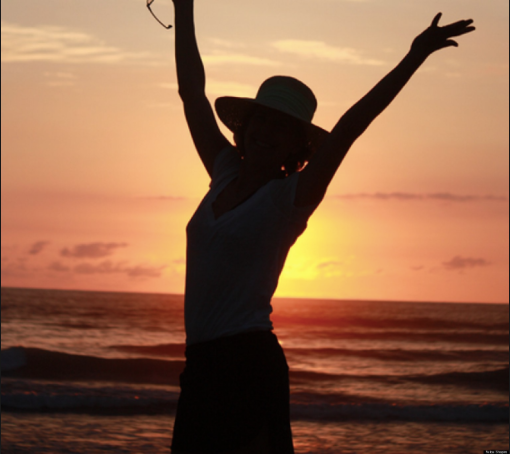 woman at sunset who is happy