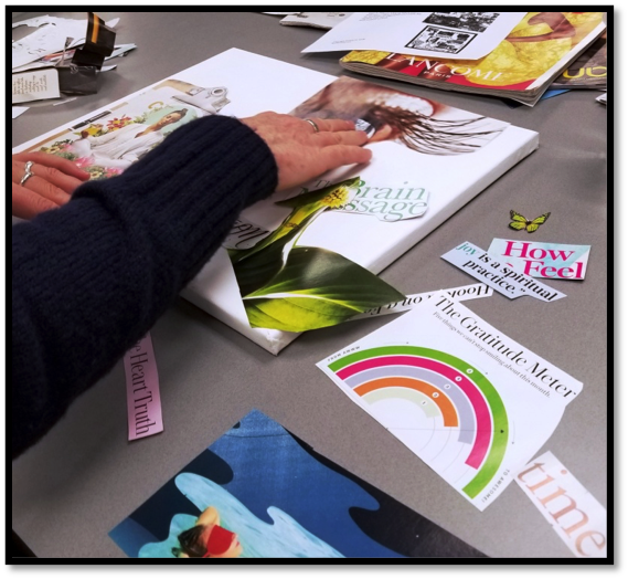 A person places a large cut of of a picture of an eye on her vision board