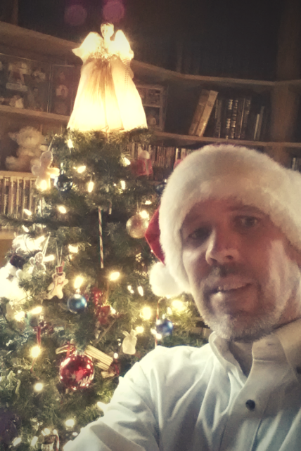Mark Koning takes a selfie by his Christmas tree